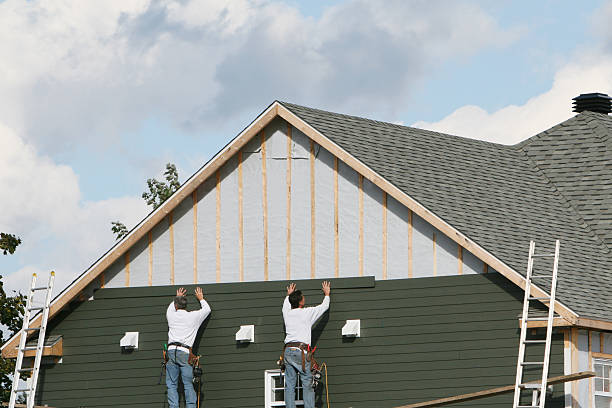 Professional Storm Damage Siding Repair technician working in Ashville, OH